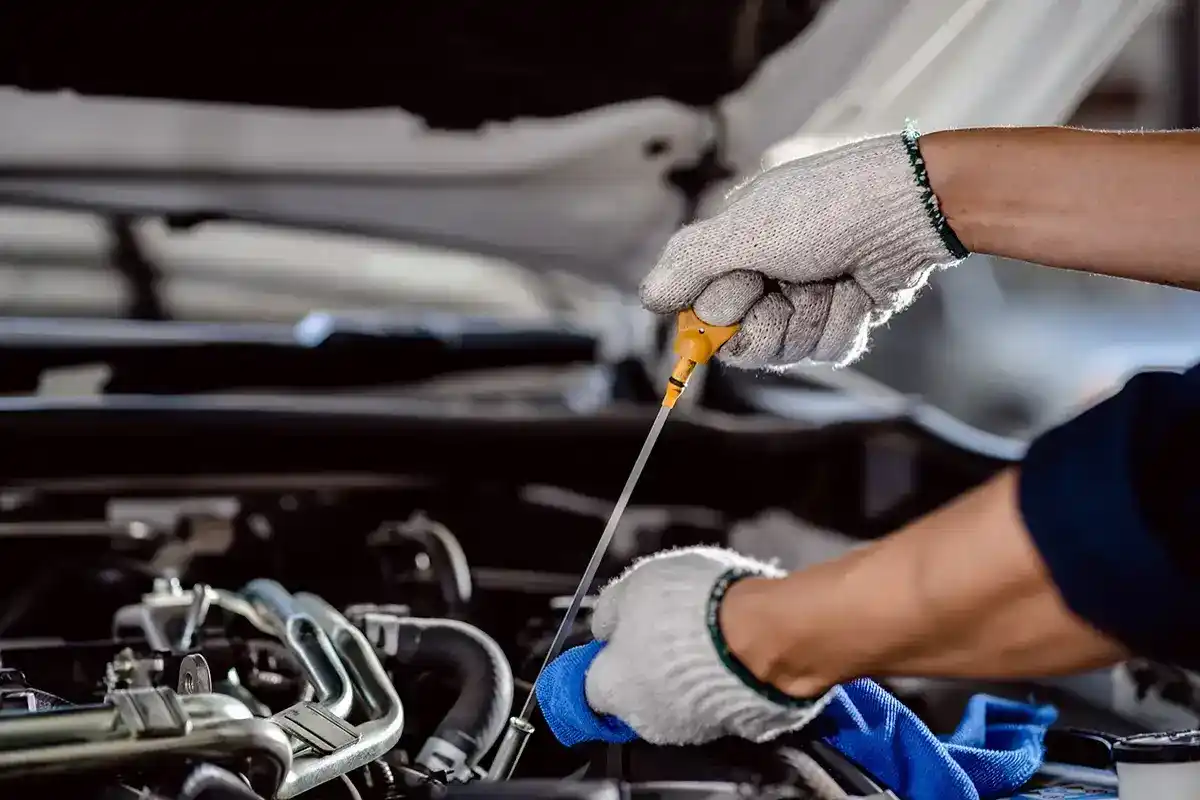 Check engine oil with a dipstick